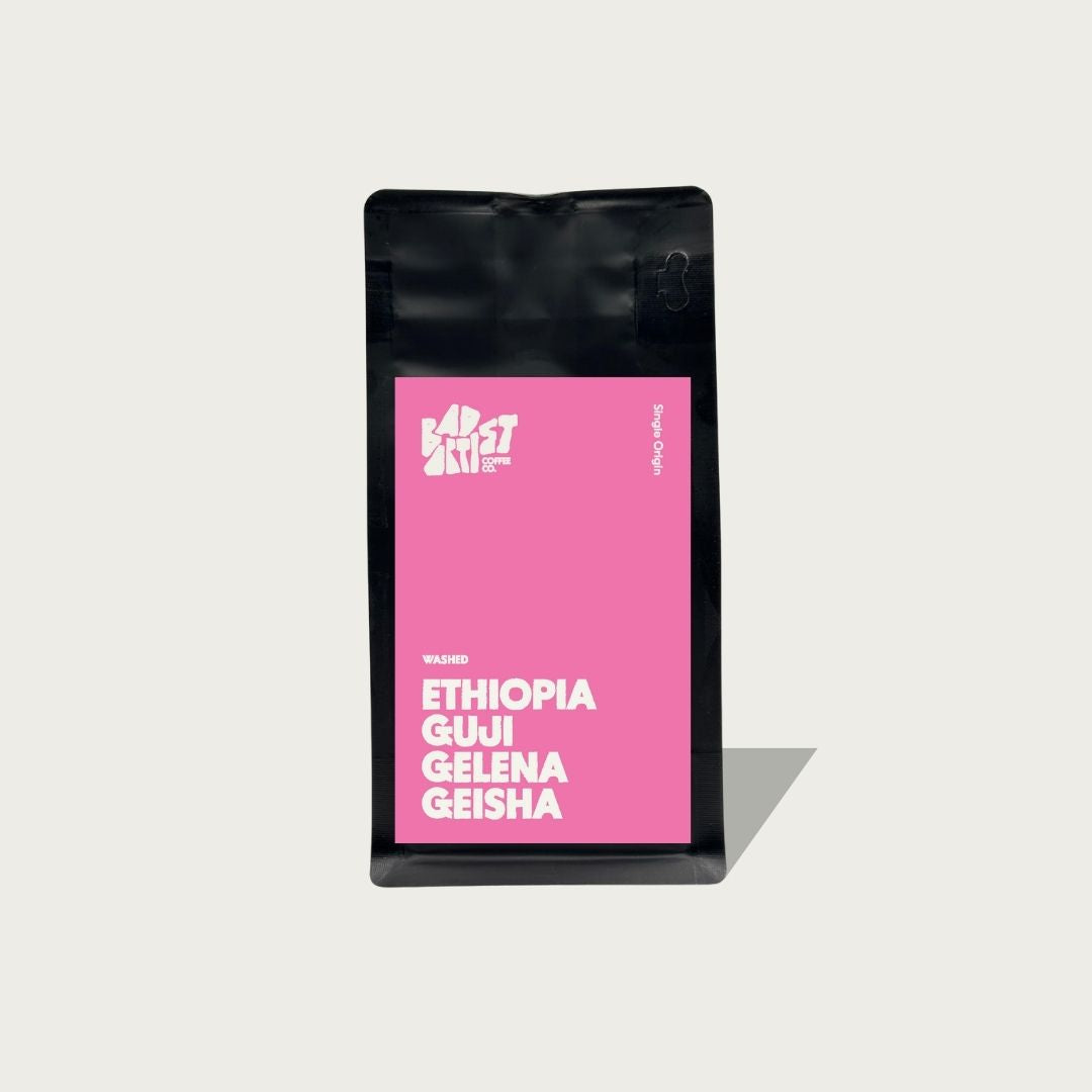 Coffee bag with pink label featuring 'Ethiopia Gui Geleña Geisha' on a light gray background