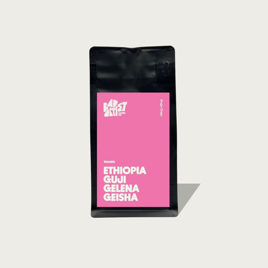 Coffee bag with pink label featuring 'Ethiopia Gui Geleña Geisha' on a light gray background